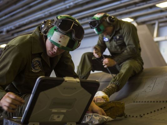 Cpl. Kendal Parish and Sgt. Arben Kupa, airframe mechanics from Marine Fighter Attack Training Squadron 501, reinstall a panel of an F-35B Lightning II after maintenance aboard a ship. (Photo: Pfc. Remington Hall/Marine Corps)