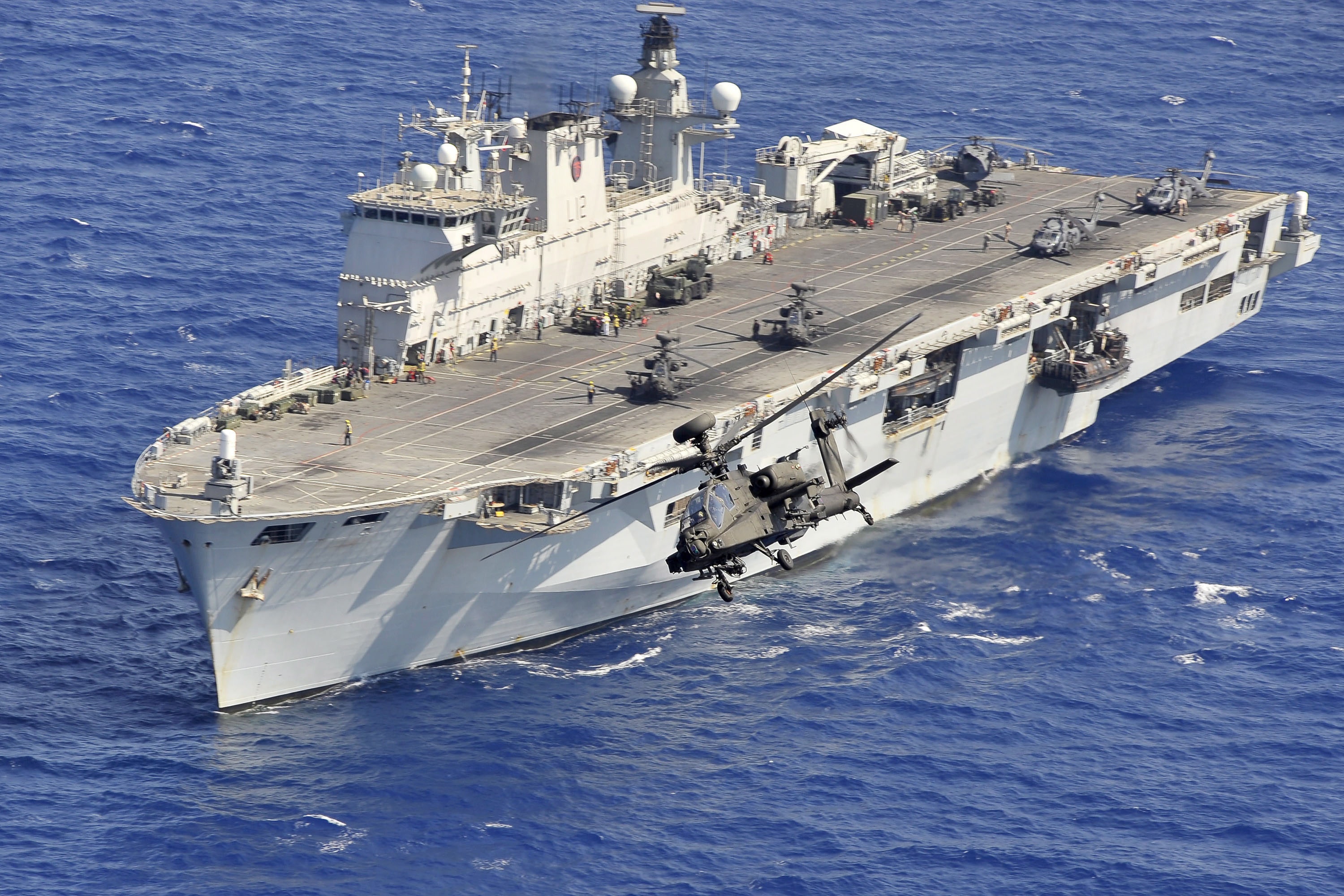 An Apache helicopter takes off from HMS Ocean during Operation Ellamy, the UK's contribution to UNSCR1973 in the Mediterranean Sea near Libya.