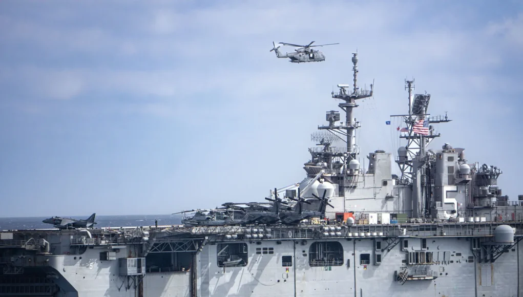 A Merlin passes over the USS Bataan