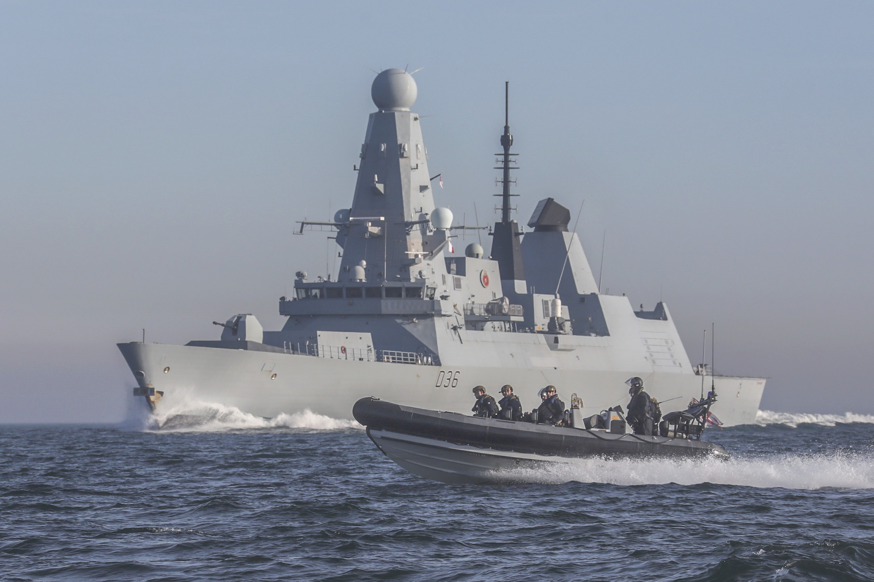 HMS Defeneder carries out boarding ops exercise.